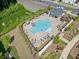 Aerial view of community pool with lounge chairs, umbrellas, and lush landscaping, perfect for relaxation and recreation at 505 Hampton Crossing, Woodstock, GA 30188