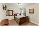 Cozy bedroom with natural light and neutral decor. Featuring hardwood furniture and carpet at 12148 Flannery Ln, Hampton, GA 30228