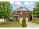 Charming two-story brick home with a well-manicured lawn and two-car garage at 12148 Flannery Ln, Hampton, GA 30228