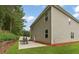 Exterior view of a two-story home with a spacious backyard, including a patio and well-maintained lawn at 12148 Flannery Ln, Hampton, GA 30228