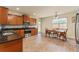 Well-lit kitchen features stainless steel appliances, dark countertops and adjacent dining area at 12148 Flannery Ln, Hampton, GA 30228
