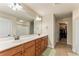 Bathroom with double vanity, a large mirror, and access to a walk-in closet at 12148 Flannery Ln, Hampton, GA 30228