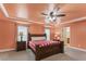 Bright main bedroom features a tray ceiling, two windows, and en-suite bathroom at 12148 Flannery Ln, Hampton, GA 30228