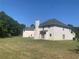 Spacious backyard featuring a well-kept lawn and a home with neutral-toned siding at 2118 Water Mill Ct, Buford, GA 30519