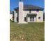 Spacious backyard featuring a well-maintained lawn and a two-story home with neutral siding and black roof at 2118 Water Mill Ct, Buford, GA 30519