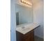 Bathroom vanity featuring a large mirror, a sink, and a light fixture at 2118 Water Mill Ct, Buford, GA 30519