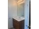 Bathroom vanity with wood cabinets and a large mirror at 2118 Water Mill Ct, Buford, GA 30519