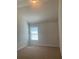 Bedroom featuring a large window and neutral carpeting at 2118 Water Mill Ct, Buford, GA 30519