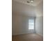 Neutral bedroom with vaulted ceilings and a window with blinds at 2118 Water Mill Ct, Buford, GA 30519