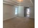 Spacious bedroom featuring a tray ceiling and plush carpeting at 2118 Water Mill Ct, Buford, GA 30519