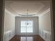 Bright dining room featuring hardwood floors, chair rail and crown molding details, and elegant chandelier at 2118 Water Mill Ct, Buford, GA 30519