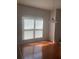 Dining area featuring hardwood floors, a pendant light, and natural light from the large window at 2118 Water Mill Ct, Buford, GA 30519