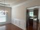Dining area featuring hardwood floors, decorative molding, and an open transition to the kitchen at 2118 Water Mill Ct, Buford, GA 30519