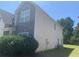 Side view of a well-maintained home exterior with stone accents and lush greenery at 2118 Water Mill Ct, Buford, GA 30519