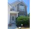 Charming home exterior featuring a stone facade, arched window, and well-maintained landscaping at 2118 Water Mill Ct, Buford, GA 30519