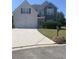 Charming two-story home featuring a two-car garage, neutral siding and a well-manicured lawn at 2118 Water Mill Ct, Buford, GA 30519