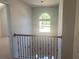 Bright hallway featuring natural light from a half-moon window and an elegant hanging light fixture at 2118 Water Mill Ct, Buford, GA 30519