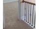 A carpeted hallway leads to another room, accentuated by wrought iron railings at 2118 Water Mill Ct, Buford, GA 30519
