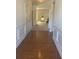 Hallway with hardwood floors, wainscoting, and a view towards the entry and living spaces at 2118 Water Mill Ct, Buford, GA 30519