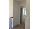 Carpeted hallway leads to a bright room with a window at 2118 Water Mill Ct, Buford, GA 30519
