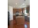 Spacious kitchen featuring wood floors, granite countertops, and stainless steel appliances at 2118 Water Mill Ct, Buford, GA 30519