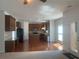 Open-concept kitchen with wood floors, granite counters, and stainless steel appliances at 2118 Water Mill Ct, Buford, GA 30519