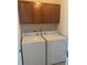 Efficient laundry room with upper cabinets and convenient, full-size washer and dryer at 2118 Water Mill Ct, Buford, GA 30519