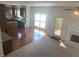 Open-concept space with hardwood floors, fireplace, and kitchen view at 2118 Water Mill Ct, Buford, GA 30519