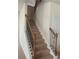 A carpeted staircase with decorative wrought iron spindles and a wood railing at 2118 Water Mill Ct, Buford, GA 30519