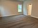 Serene bedroom with soft carpeting, a bright window, and a door leading to an adjacent room, creating a cozy retreat at 3382 Milan Ct # 3 Appx/Plan Sqft 3327, Douglasville, GA 30135
