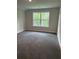 Carpeted bedroom featuring a large window with green views at 3382 Milan Ct # 3 Appx/Plan Sqft 3327, Douglasville, GA 30135