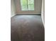 Cozy carpeted bedroom featuring a large window with green views at 3382 Milan Ct # 3 Appx/Plan Sqft 3327, Douglasville, GA 30135