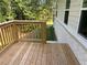 A wooden deck with railing is attached to the rear of the home with a lush, wooded backyard view at 3382 Milan Ct # 3 Appx/Plan Sqft 3327, Douglasville, GA 30135
