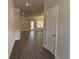 Inviting hallway with modern gray wood-look flooring leading to living area at 3382 Milan Ct # 3 Appx/Plan Sqft 3327, Douglasville, GA 30135