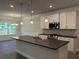 Bright kitchen with white cabinets, a stainless steel range, and a central island featuring a sink and counter space at 3382 Milan Ct # 3 Appx/Plan Sqft 3327, Douglasville, GA 30135