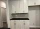 Charming kitchenette with white cabinets, dark countertops, and herringbone backsplash at 3382 Milan Ct # 3 Appx/Plan Sqft 3327, Douglasville, GA 30135