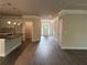Open-concept living area with gray wood-look flooring and view of front door at 3382 Milan Ct # 3 Appx/Plan Sqft 3327, Douglasville, GA 30135