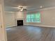 Spacious living room featuring a fireplace and large windows providing natural light at 3382 Milan Ct # 3 Appx/Plan Sqft 3327, Douglasville, GA 30135