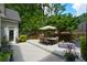 Inviting backyard with a spacious deck, dining table, and lush landscaping at 700 Broadlands Ln, Powder Springs, GA 30127