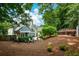 Expansive backyard with a patio, mature trees, and lush landscaping at 700 Broadlands Ln, Powder Springs, GA 30127