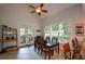 Bright dining area with a vaulted ceiling, a ceiling fan, a table with seating for six, and access to the outdoors at 700 Broadlands Ln, Powder Springs, GA 30127