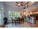 Open-concept dining area connected to the kitchen, featuring a breakfast bar, vaulted ceiling, and views of the upper level at 700 Broadlands Ln, Powder Springs, GA 30127
