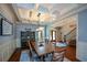 Beautiful dining room with hardwood floors, coffered ceilings, a decorative light fixture and plenty of room to gather at 700 Broadlands Ln, Powder Springs, GA 30127