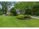 Manicured lawn leads to this home featuring stone accents and beautifully landscaped beds at 700 Broadlands Ln, Powder Springs, GA 30127