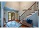 Inviting foyer featuring hardwood floors, staircase with iron railing, and natural light at 700 Broadlands Ln, Powder Springs, GA 30127