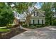 Charming home featuring stone accents, landscaped yard, mature trees, and long driveway at 700 Broadlands Ln, Powder Springs, GA 30127