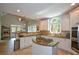 Spacious kitchen featuring white cabinetry, granite counters, a center island with cooktop, and stainless steel appliances at 700 Broadlands Ln, Powder Springs, GA 30127