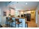 Bright and modern kitchen with white cabinets, granite countertops, stainless steel appliances, and breakfast bar seating at 700 Broadlands Ln, Powder Springs, GA 30127