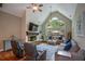 Bright living room with vaulted ceiling, stone fireplace, and large windows at 700 Broadlands Ln, Powder Springs, GA 30127