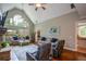 Spacious living room with a stone fireplace, vaulted ceiling, and large windows at 700 Broadlands Ln, Powder Springs, GA 30127
